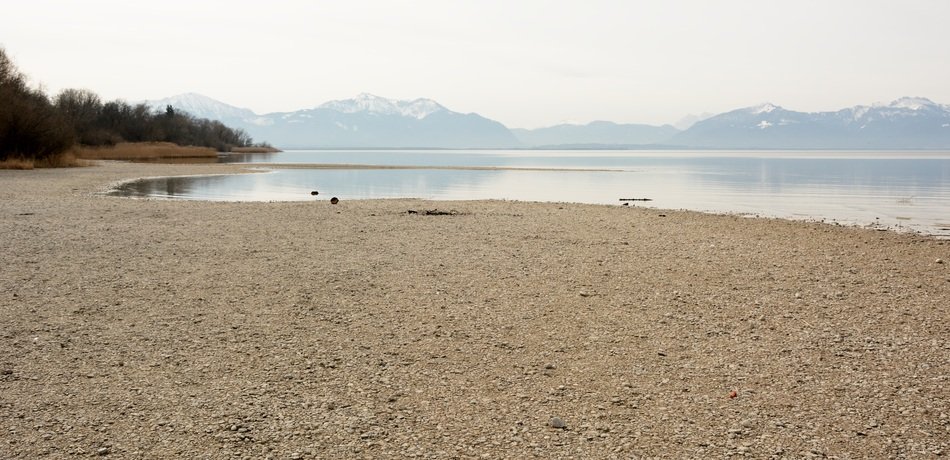 landscape of river bank with mountains on the background