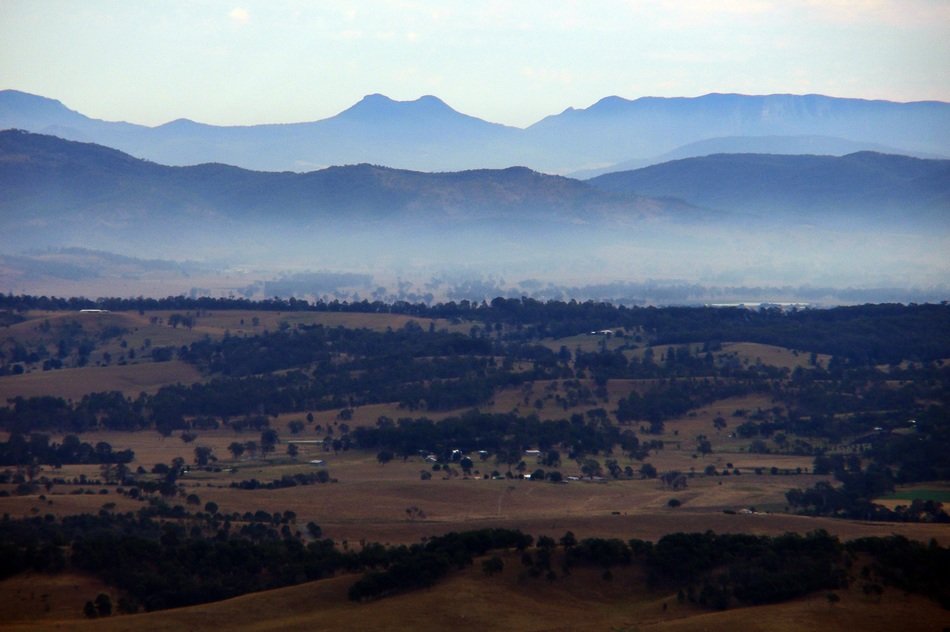 picturesque rural landscape on a background of mountains in the haze, Australia