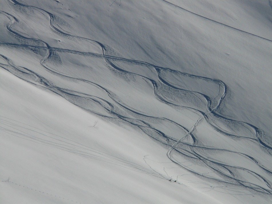 tracks in the snow in the glare of light and shadow