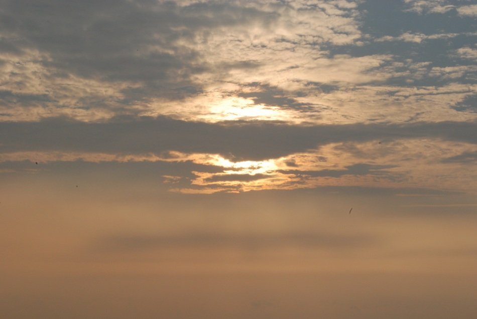 landscape of the sun through the clouds in the evening sky