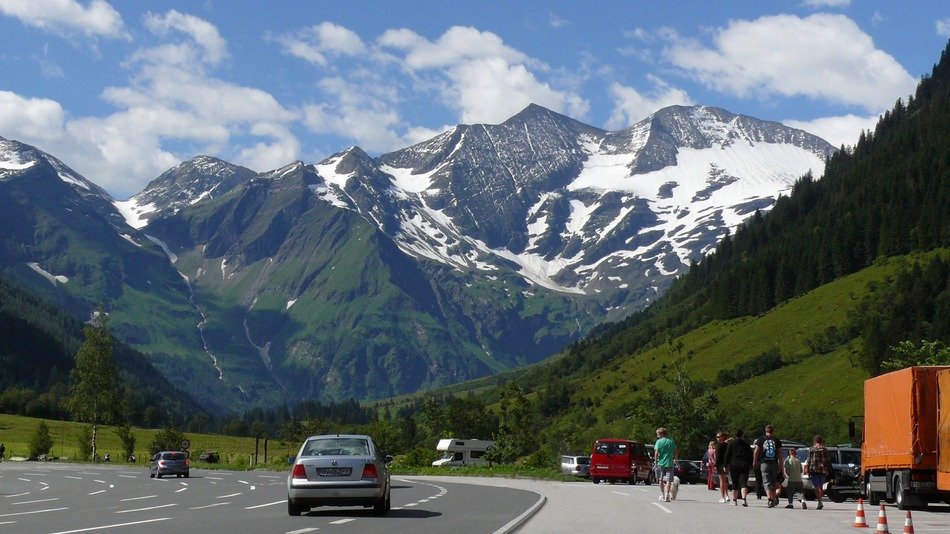 Road in alps mountains view with cars free image download