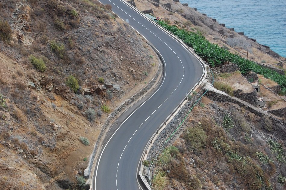 Landscape with the wavy road near the water