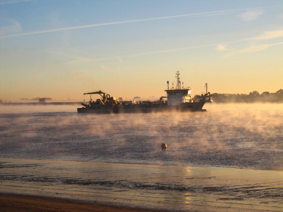 sunrise on the background of the ship in the ocean