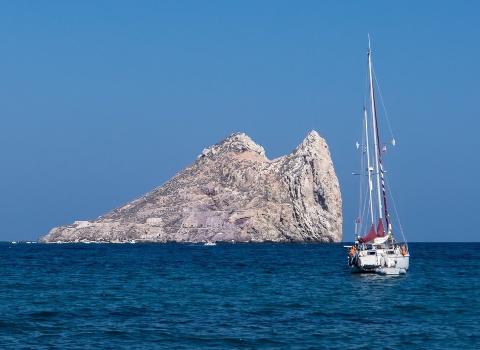boat near the cliff at sea