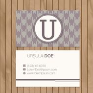 Business card with alphabet letter on a wood background N13