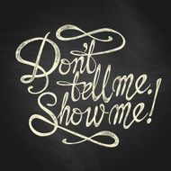 &quot;Don&#039;t Tell Me Show Me&quot; quote on the blackboard background