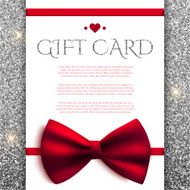 Gift card with red bow on silver glitter background