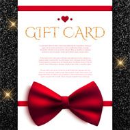 Gift card with red bow on shiny glitter background