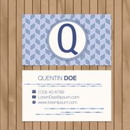 Business card with alphabet letter on a wood background N21
