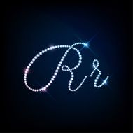 Diamond glittering letter R of sparkling brilliants