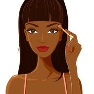 Attractive woman with dark skin applying eyeshadow makeup