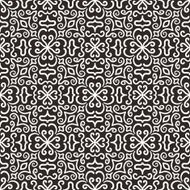 White graphic flower pattern on dark background