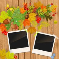 photo frame on wooden texture with autumn leaves
