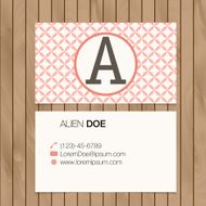 Business card with alphabet letter on a wood background N26