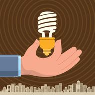 Hand holding a compact fluorescent light bulb