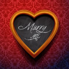 Marry Me written by chalk on heart shaped board