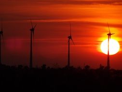 bright sun, scarlet sunset over windmills