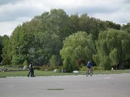 landscape of walking people in the city park in summer