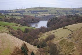 Panoramic view of the beautiful lake among the colorful plants in the valley in countryside