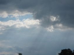 bright sunlight through dark clouds