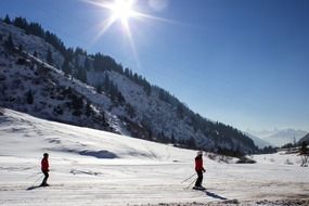 people ride in the snow on the mountain