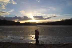 child by the frozen lake