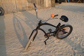 bike on the sandy beach near the fence