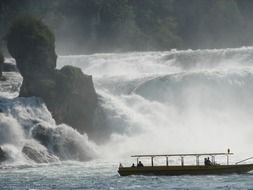 Boat near the waterfall in Switzerland
