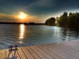 sun at sunset over the lake