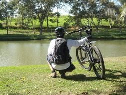 cyclist sitting by the river