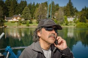 Fishing man calling by phone