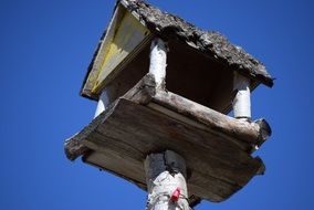 wooden nesting box on the sky background