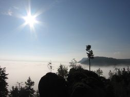 bright sun over the foggy mountains