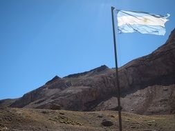 Flag of Argentina among the beautiful and colorful Andes mountains