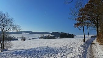 path along snowy field, rural landscape