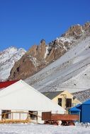 houses at the foot of a snowy mountain in Argentina