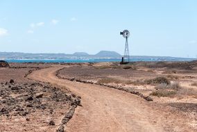 pinwheel at soil road in wilderness, spain, los lobos island