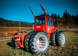 Red tractor in a field on a sunny day