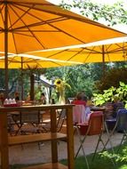 garden cafe with orange umbrellas