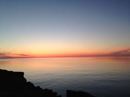 orange sky at sunset on the horizon of the lake