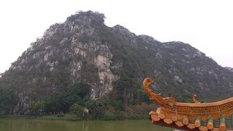 detail of traditional oriental carved roof at mountain