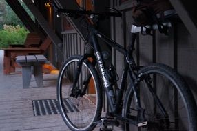 black mountain bike on the veranda of the house