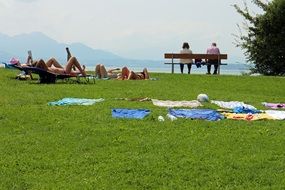 people rest on the green lawn