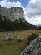 view of the Dolomites on the backdrop of huge clouds