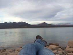 vacation traveler on the shore of a mountain lake