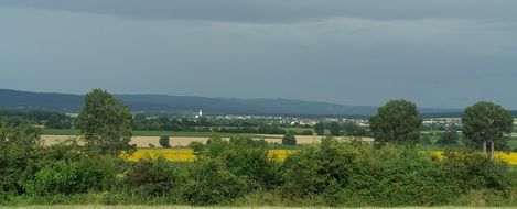 panorama of green field and dark clouds