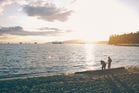 people on the beach at the lake