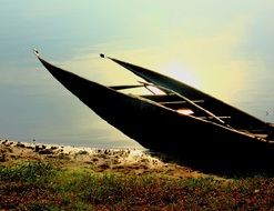 Sunken boat on the colorful coast in light
