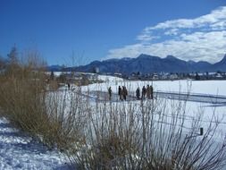 People on ice at the lake in winter