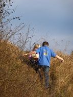 children among the dry tall grass